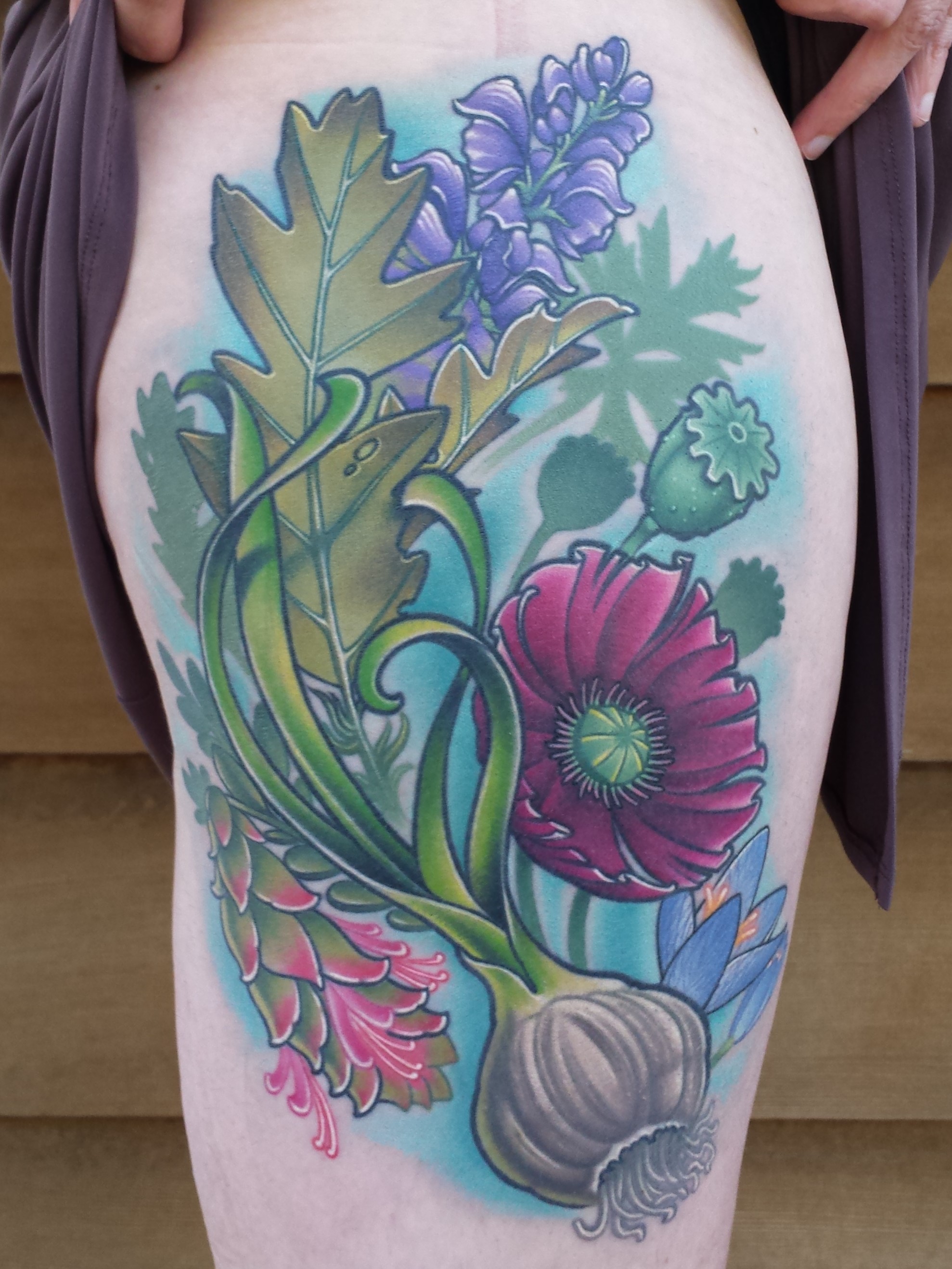 Flowers and Garlic thigh tattoo by Cracker Joe Swider out of CT
